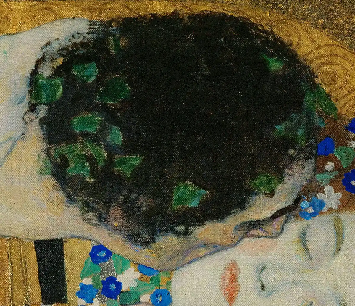 Close detail of the gold robes in Klimt's The Kiss showing metal leaf, raised ornament and tooled pattern