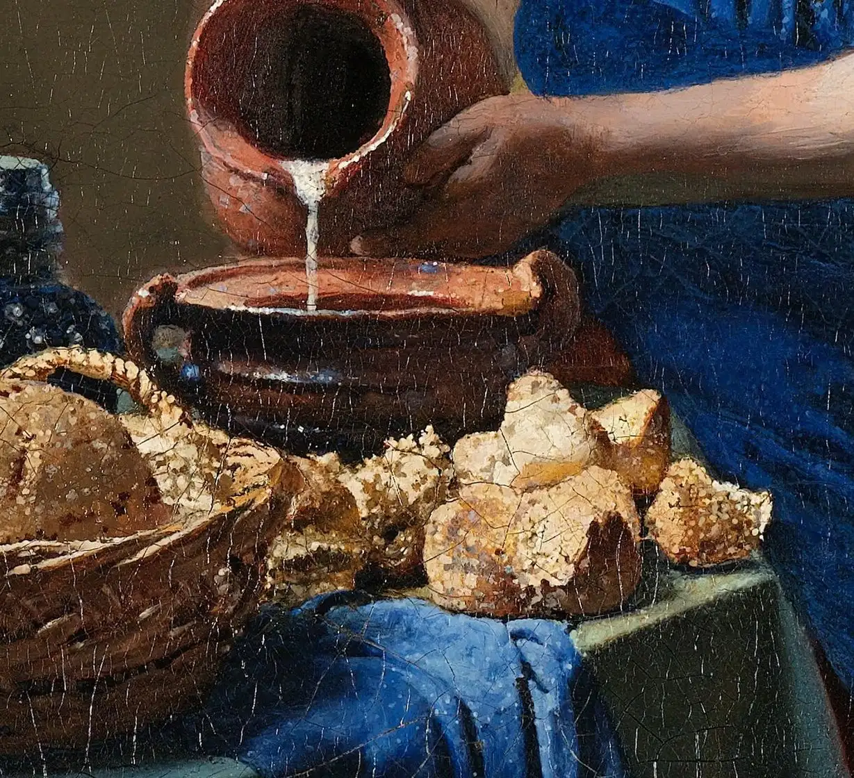 Macro detail of the bread and jug in Vermeer's The Milkmaid showing raised dots of light paint