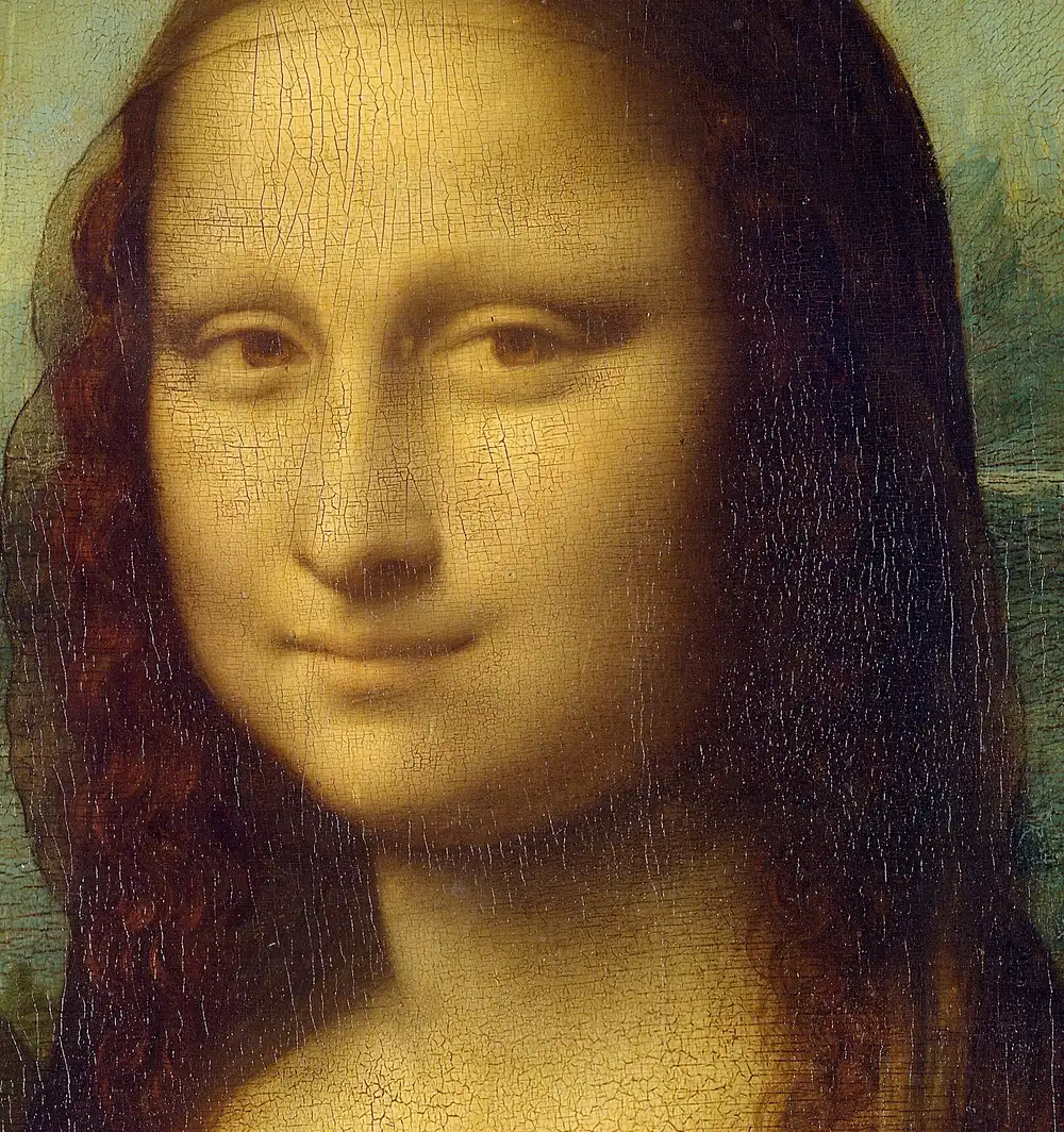 Detail of the Mona Lisa's face showing soft edgeless transitions, a network of fine cracks, and the yellow cast of aged varnish.