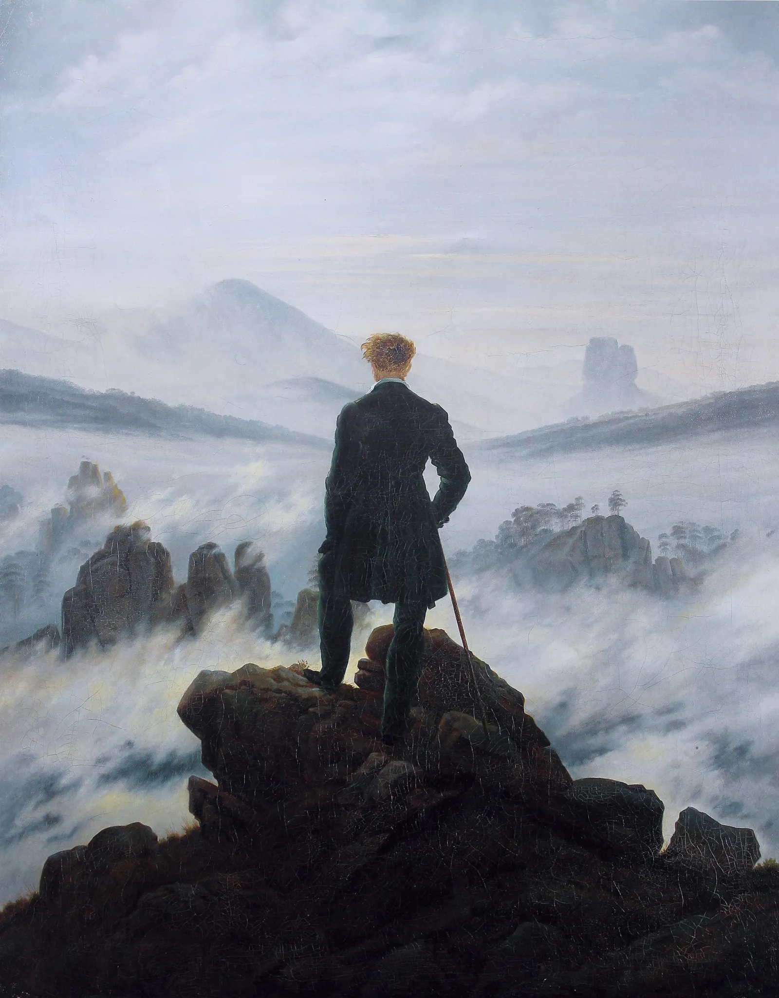 Caspar David Friedrich's Wanderer above the Sea of Fog: a man in a dark green coat stands on a rock, seen from behind, looking over a landscape filled with fog.
